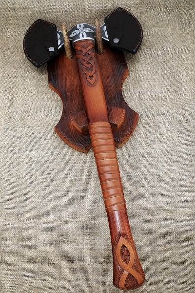 Axe-axe with a carved ash pattern on a stand